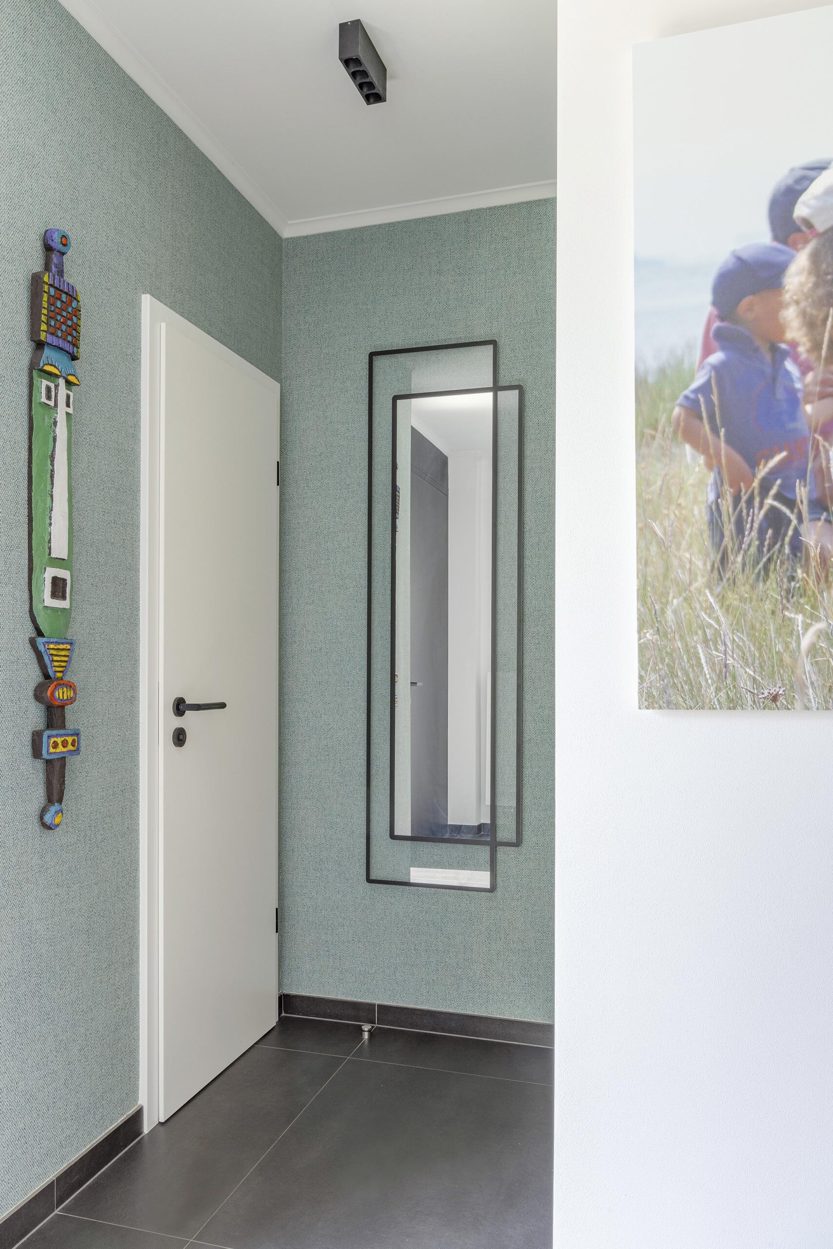Hall d’entrée contemporain avec papier peint texturé, couleurs enveloppantes et mobilier sur mesure, dans une ambiance élégante, chaleureuse et haut de gamme